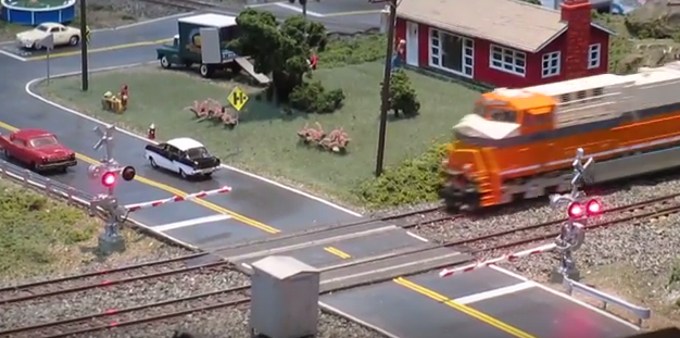 model train locomotive at level crossing