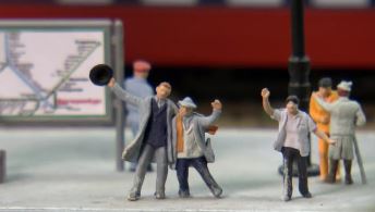 people in scene on model railroad